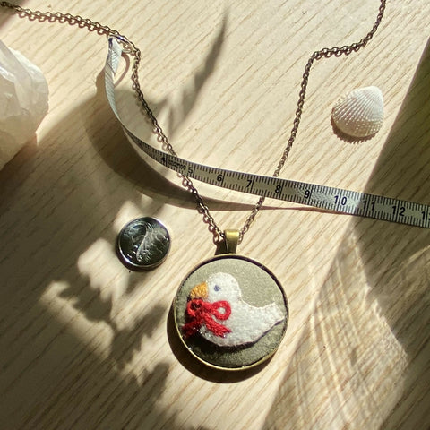 Dove with Red Ribbon copper-colour necklace