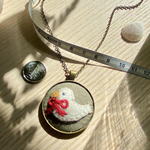 Dove with Red Ribbon copper-colour necklace