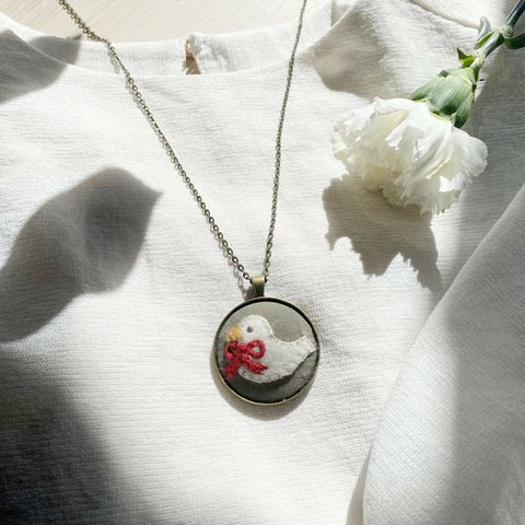 Dove with Red Ribbon copper-colour necklace
